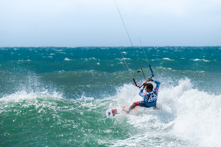 Amazing kite surfing at Philippines. Processional instructor surfing in ocean waivesの写真素材