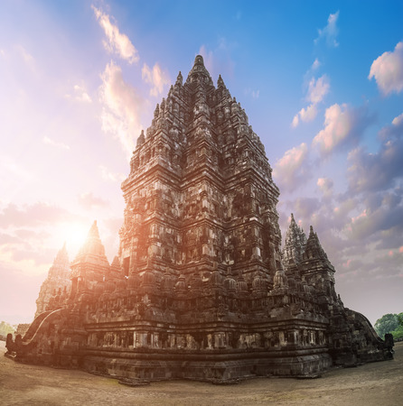 Beautiful buildings of ancient Prambanan or Rara Jonggrang Hindu temple complex against shining morning sun on background. Java, Indonesia.の写真素材