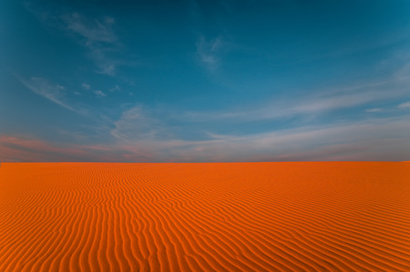 Stunning view of rippled sand dunes under amazing blue sky at drought desert landscape. Global warming concept.の写真素材