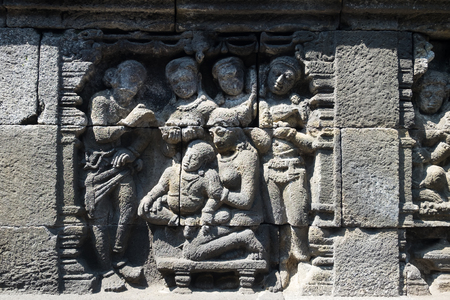 Closeup wall ornamented with bas-reliefs religion scene. Highly detailed stone carving. Borobudur Buddhist temple, Magelang, Indonesiaの写真素材