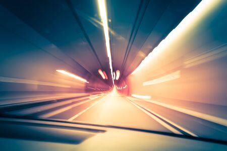 Abstract traffic background. Dark underground tunnel with blurred light tracks. Motion blurの写真素材