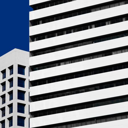 Abstract minimal style architecture background. Modern building facade detail over blue skyの写真素材