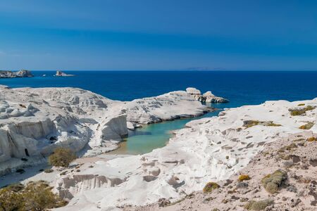 Amazing landscape with white volcanic rocks at Sarakiniko beach. Turquoise Aegean sea and blue sunny sky. Unique mediterranean nature of Milos island, Greece. Travel destination and vacation paradiseの写真素材