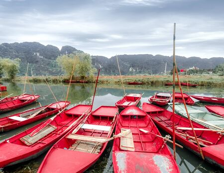 Amazing morning view with Vietnamese boats at river. Tam Coc, Ninh Binh,. Vietnam travel landscape and destinationsの写真素材