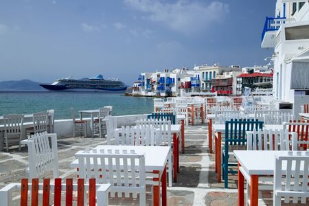 Outdoor restaurant with sea view near romantic colorful Little Venice at sunny day. Yachts on Aegean sea. Amazing touristic place, People walking along promenade, Alefkandra area. Greece vacationの写真素材