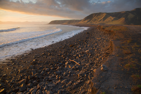 Sunset on scenic Palliser Bay coastline, Wairarapa, New Zealandの写真素材