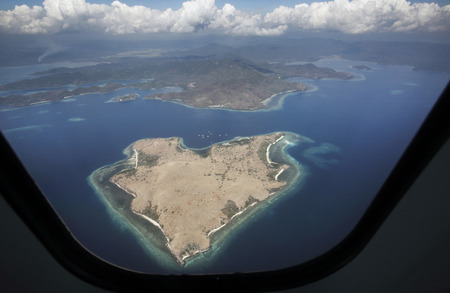 Heart shaped island viewed from plane in Nusa Tenggara, Indonesiaの写真素材