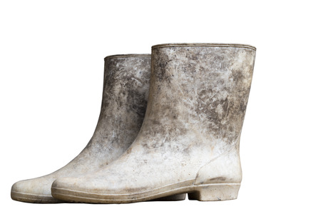muddy boots on white backgroundの写真素材