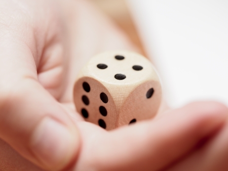 A hand throwing the dice