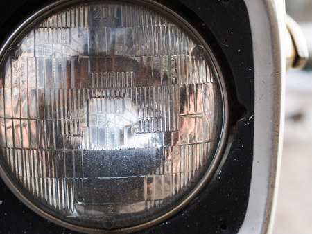 Old round headlight of a car