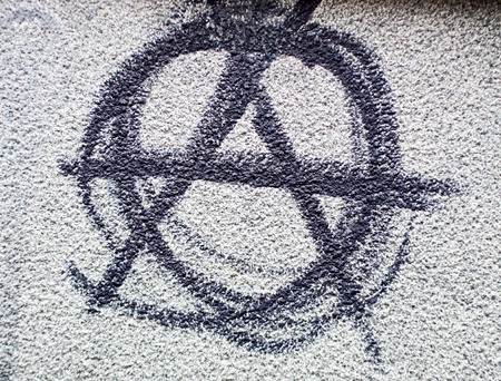 Sign for anarchism on a stone wall
