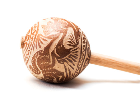 A mexican wooden maraca on a white background
