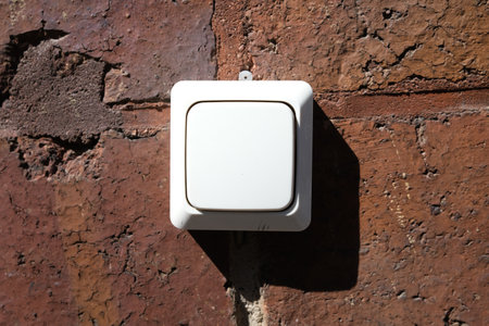 Plastic switch on a red brick wallの写真素材