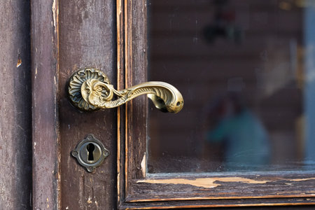 Old door handle on a wooden doorの写真素材