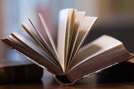 Old open book on a wooden tableの写真素材