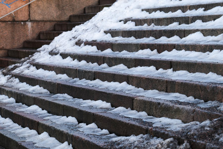 Snow and ice on the stairs in winterの写真素材