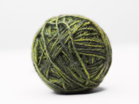 Green ball of wool on a white background