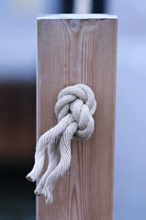 A knot on a wooden rope fence