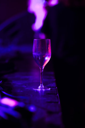 Glass on a table in dark lightingの写真素材