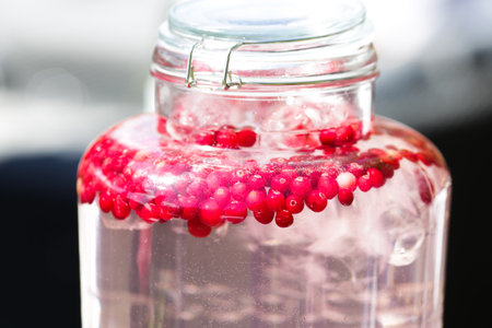 Glass bottle with fresh berries