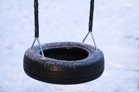 A tire swing in the winterの写真素材