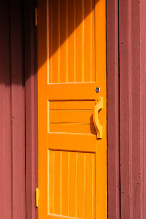 Wooden orange door of a building