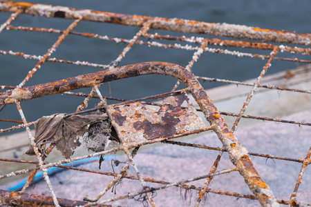 Rusty metal fence which was in the sea