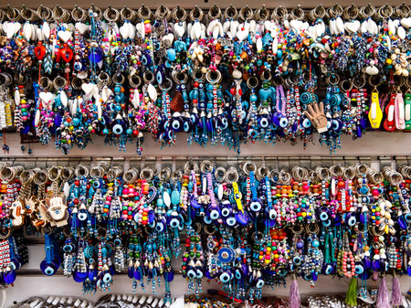 Traditional evil eye bead - protection amulet on keychain at souvenir store. Popular tourist souvenir and talisman in different countries around the world. Symbol of protection against malevolent gazesの写真素材