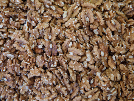 Big kernels walnuts full frame background. Close up of big shelled walnuts. Walnut background, scattered pile of peeled walnuts. top view. Vegetarian or eating healthy.の写真素材