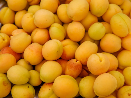 Ripe yellow apricots fruit on a local farmer street fruit vegetables market, ecological food, full frame backgroundの写真素材