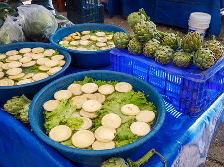 Freshly peeled artichokes in blue basins at the local market in the Mediterranean. It is sold in water with lemon so that the artichokes do not turn black. top view. Turkeyの写真素材