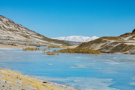View from Tarahta river valley to South Chui ridge in winter day. Russia South Of Western Siberia, Altai Mountains. Desert mountains covered with snow near village of Kosh-Agachの写真素材