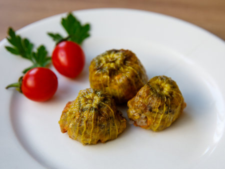 Traditional delicious Turkish - Greek cuisine, Turkish food Stuffed zucchini flowers (Turkish name kabak cicegi dolmasi) on white plate. close upの写真素材