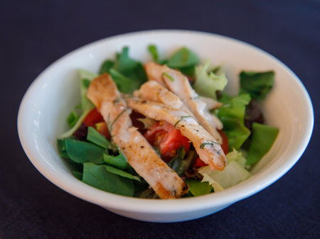 Italian salad with chicken meat. Fresh vegetable salad with chicken breast. Meat salad with chicken fillet and fresh vegetables in bowl, top viewの写真素材
