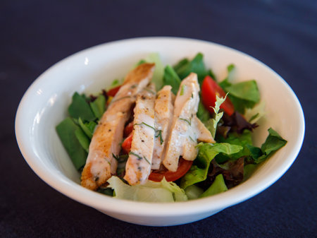 Italian salad with chicken meat. Fresh vegetable salad with chicken breast. Meat salad with chicken fillet and fresh vegetables in bowl, top viewの写真素材