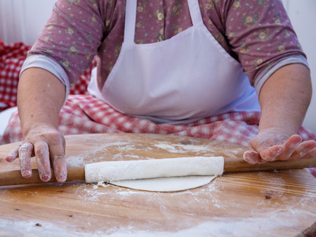 Process of making a traditional Turkish dough is called Gozleme, selective focus. It is made of flat bread stuffed with meat or cheese and baked on sheet iron or pan. Baked in a pan called a saj.の写真素材