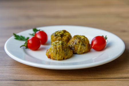 Traditional delicious Turkish - Greek cuisine, Turkish food Stuffed zucchini flowers (Turkish name kabak cicegi dolmasi) on white plate. side viewの写真素材