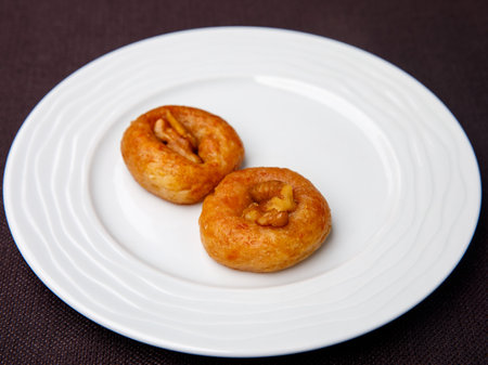 Turkish Dessert Sekerpare on white plate. Small cakes with Almond and Sherbet Syrup, top viewの写真素材