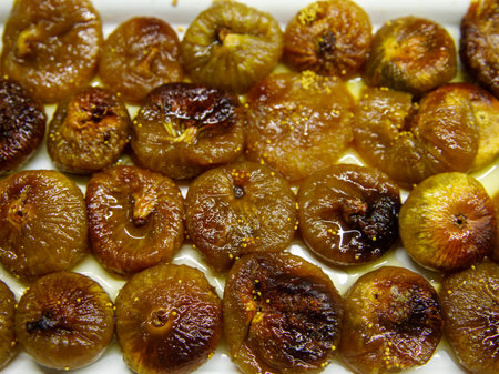 Dry fig dessert with sweet syrup as Turkish traditional sweet. Turkish name Incir Receli. Top view full frame background.の写真素材