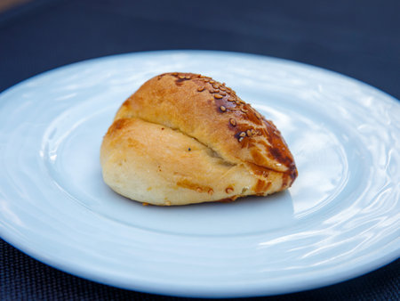 Traditional turkish bun pastry product , tasty pogaca with cheese filling on white plate close upの写真素材