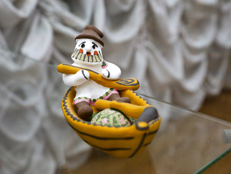 Kargopolskaya toy, man with beard in boat with oars. Traditional Kargopol clay toy (Russian North). folk art. Souvenir from Russia.の写真素材