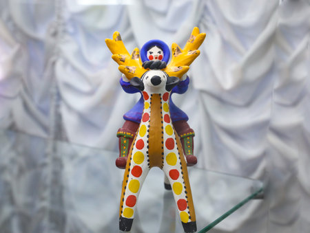 Chukchi or eskimos sitting on reaideerin dymkovo painting style with circles. Handicrafts and toys made by Russian craftsmen in national traditions of Russia. Dymkovskaya clay toy. folk art souvenirの写真素材
