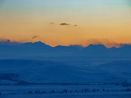 View from Kurai steppe to North Chui ridge in winter sunset. Russia. South Of Western Siberia, Altai Mountains. Desert mountains covered with the snow near the village of Kurai.の写真素材