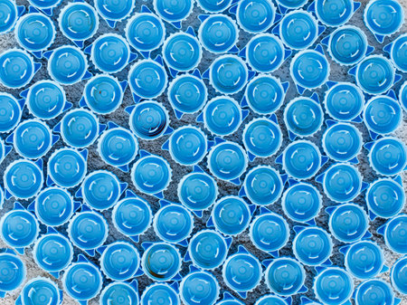 Small blue plastic bottle caps background. Recycling collection and production processing plastic bottle caps. top view, copy spaceの写真素材