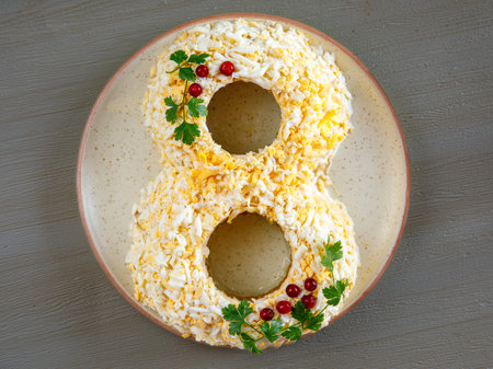 Festive egg, cheese, apple, onion salad in form of number eight, International Women's Day, child birthday, wedding anniversary., Top view on dark background, Close up.の写真素材