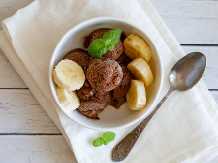 Healthy raw vegan banana and chocolate ice cream (icecream or nicecream) - healthy vegetarian diet, vegan raw fruit organic delicious dessert, dairy free, gluten free summer dessert. top viewの写真素材