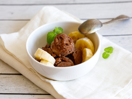 Healthy raw vegan banana and chocolate ice cream (icecream or nicecream) - healthy vegetarian diet, vegan raw fruit organic delicious dessert, dairy free, gluten free summer dessert.の写真素材