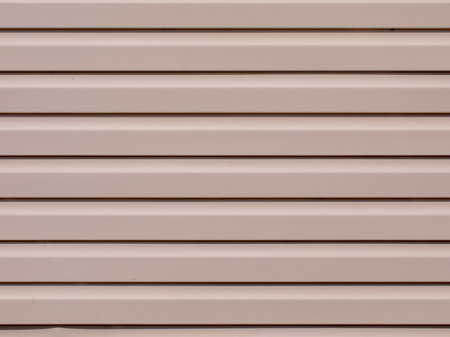 Plastic siding surface in pink tone. House wall, abstract background and texture.の写真素材