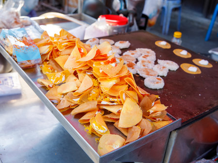 Khanom Buang Thai or a kind of filled pancake Thai food or Thai Style small Crispy Tart on local market tray, Thailand.の写真素材