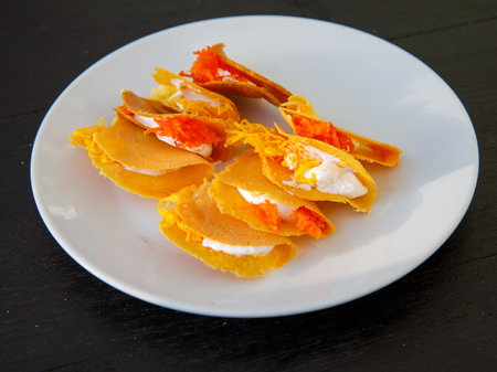 Khanom Buang Thai or a kind of filled pancake Thai food or Thai Style small Crispy Tart on white plate, Thailand.の写真素材